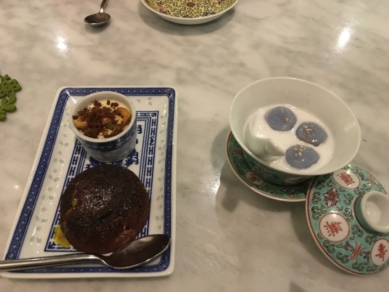 (Western) chocolate cake next to a loca dessert of glutunous rice with coconut