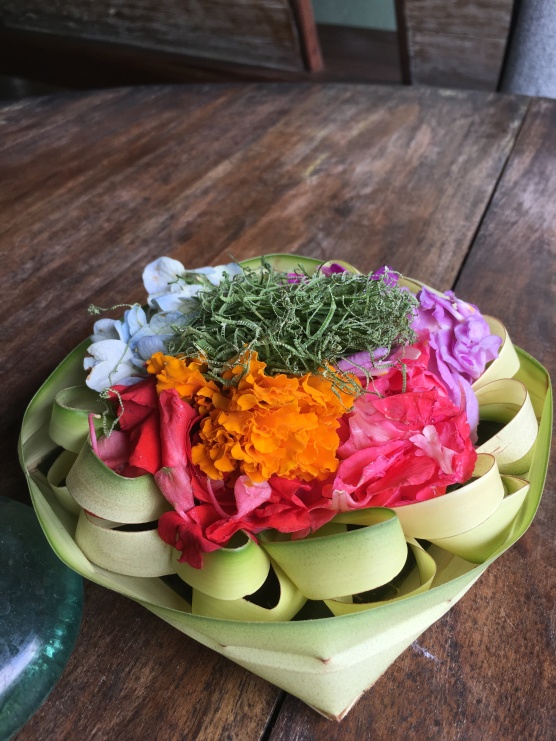 Palm basket with a daily offering of flowers and rice for the spirits